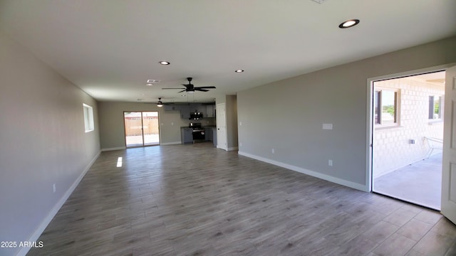 4219 W Citrus Way, Phoenix, AZ 85019 - unfurnished living room featuring recessed lighting, wood finished floors, baseboards, and ceiling fan