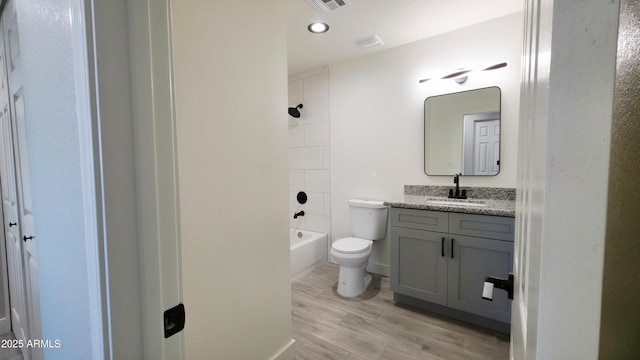 4219 W Citrus Way, Phoenix, AZ 85019 - bathroom with toilet, wood finished floors, vanity, shower / washtub combination, and recessed lighting