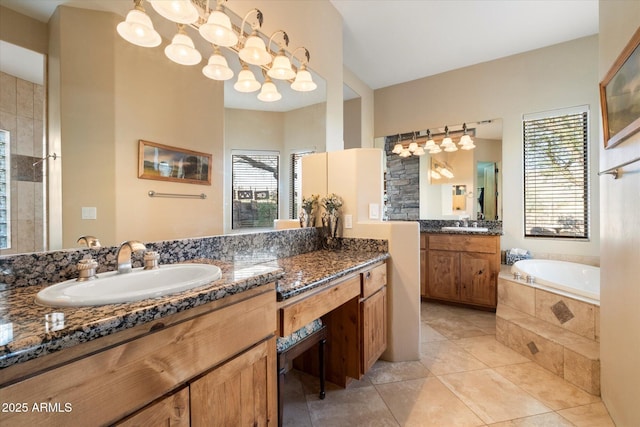 bathroom featuring vanity, tiled bath, and tile patterned floors