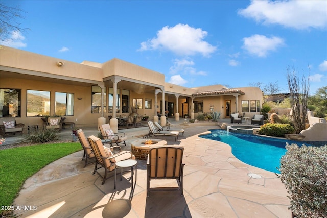 view of pool with a patio area and an outdoor fire pit