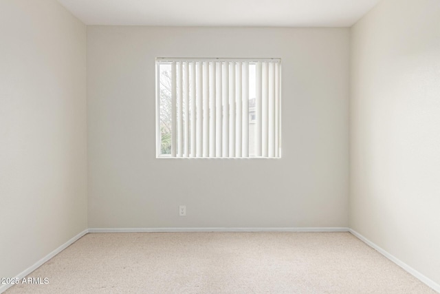 carpeted empty room with baseboards