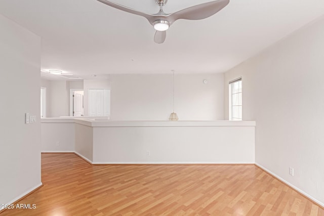 empty room featuring baseboards and wood finished floors