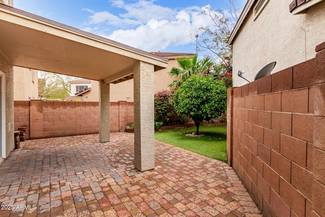 view of patio featuring fence