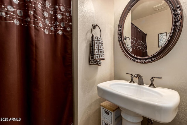 6160 S Pebble Beach Dr, Chandler, AZ 85249 - full bathroom featuring a sink, a textured wall, and a shower with shower curtain