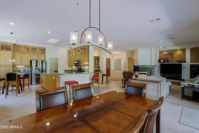 dining space featuring light tile patterned floors, ceiling fan with notable chandelier, recessed lighting, and visible vents