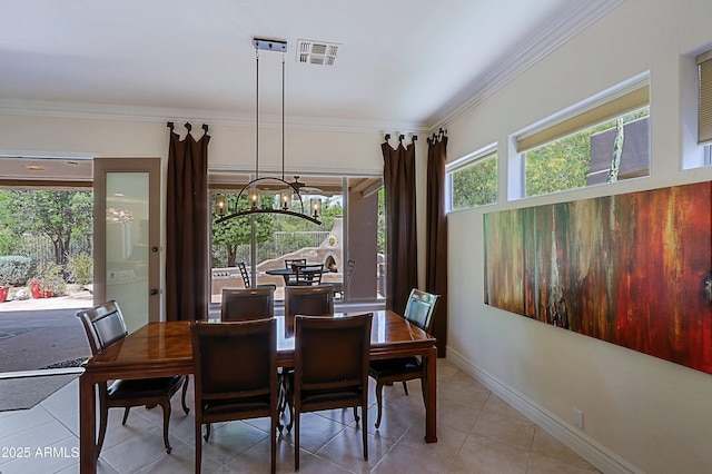 tiled dining space with visible vents, ornamental molding, baseboards, and an inviting chandelier