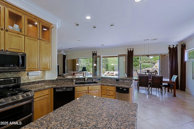 kitchen with stainless steel appliances, a wealth of natural light, a sink, and a peninsula