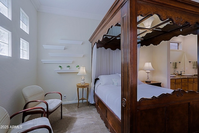bedroom with carpet floors, connected bathroom, baseboards, and ornamental molding