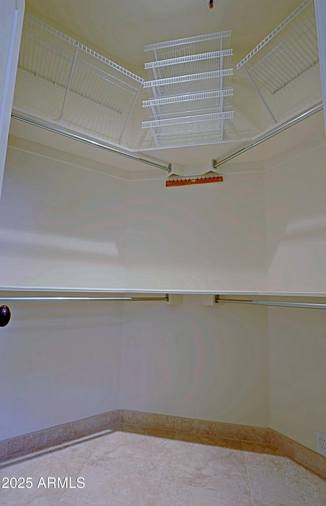 spacious closet featuring tile patterned flooring