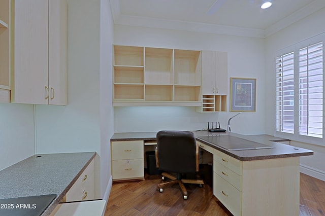 office featuring crown molding, plenty of natural light, dark wood finished floors, and built in desk