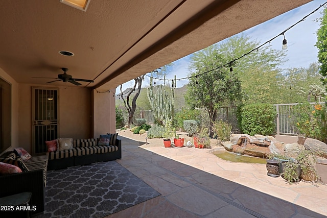 view of patio with a fenced backyard, a ceiling fan, and an outdoor hangout area