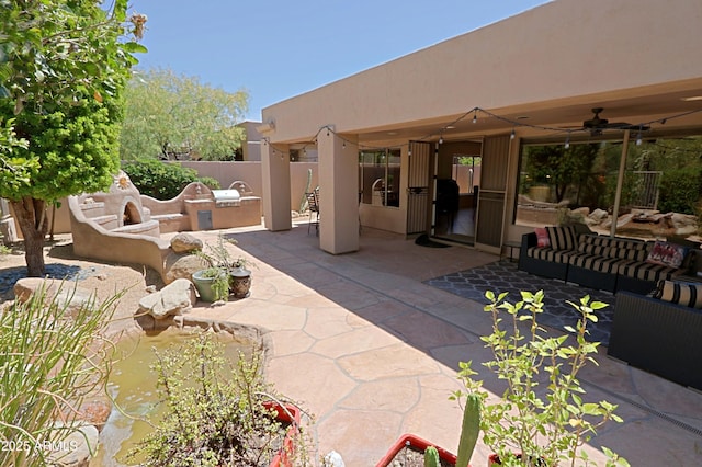 view of patio / terrace with an outdoor hangout area, a ceiling fan, area for grilling, and fence
