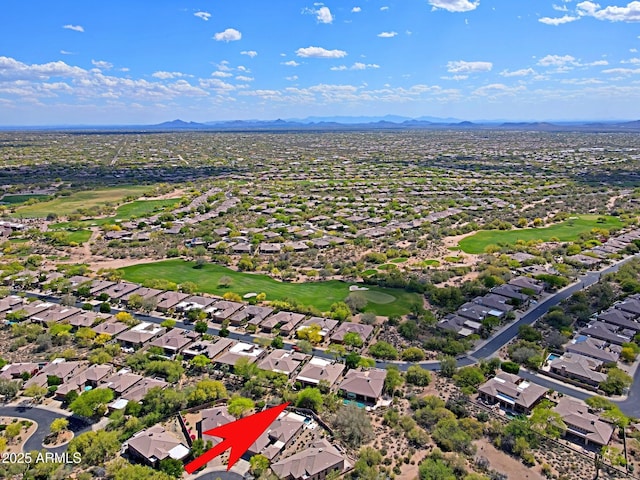 drone / aerial view with a residential view, a mountain view, and view of golf course