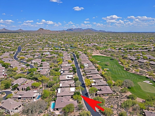 drone / aerial view with a residential view, a mountain view, and view of golf course
