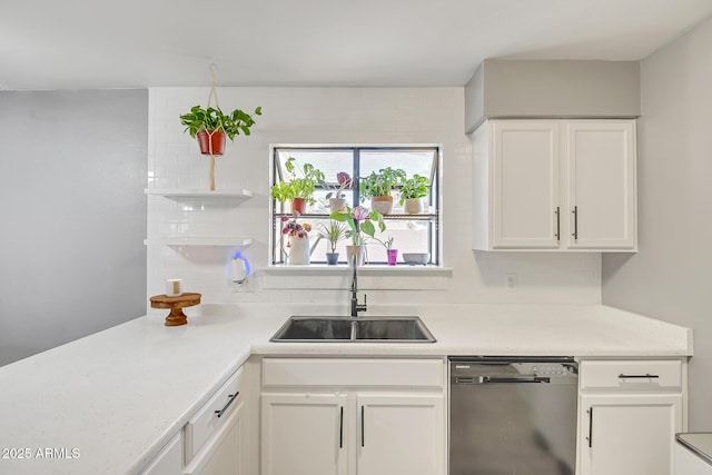 kitchen featuring a sink, light countertops, white cabinetry, and dishwasher