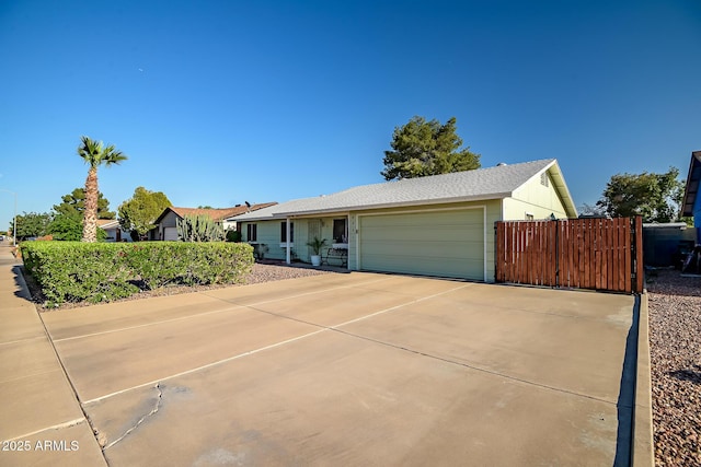 single story home with an attached garage, fence, and driveway