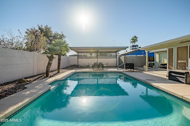 view of swimming pool with a fenced backyard, a fenced in pool, and a patio area