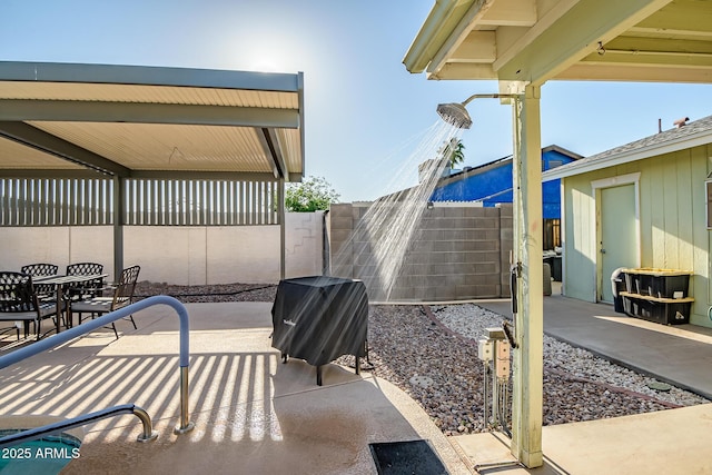 view of patio featuring outdoor dining space and fence
