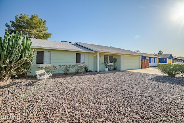 single story home with driveway and an attached garage