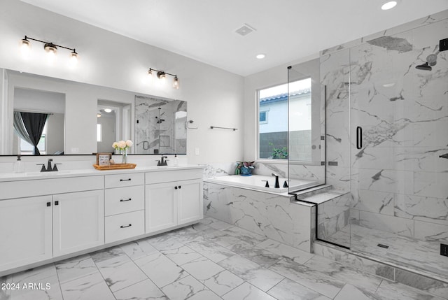 bathroom featuring vanity, shower with separate bathtub, and a wealth of natural light