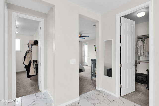 hallway featuring light colored carpet