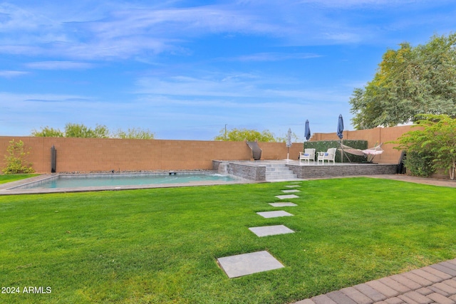 view of yard with a fenced in pool, pool water feature, and a patio