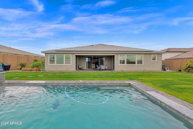 view of pool with a yard and a patio area