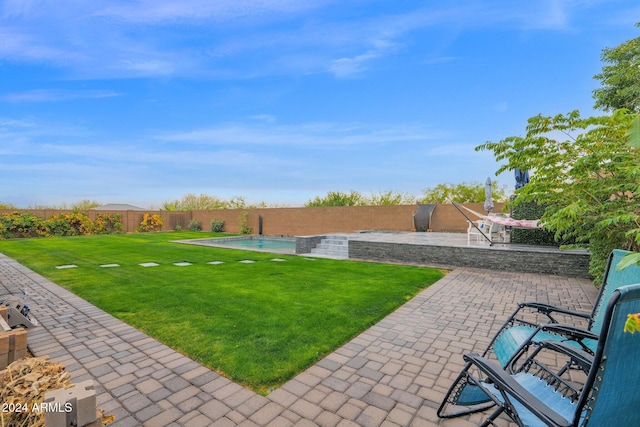 view of yard featuring a fenced in pool and a patio