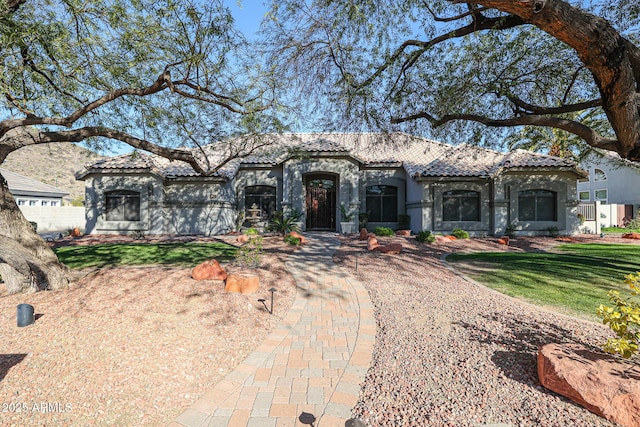 mediterranean / spanish house with a front yard