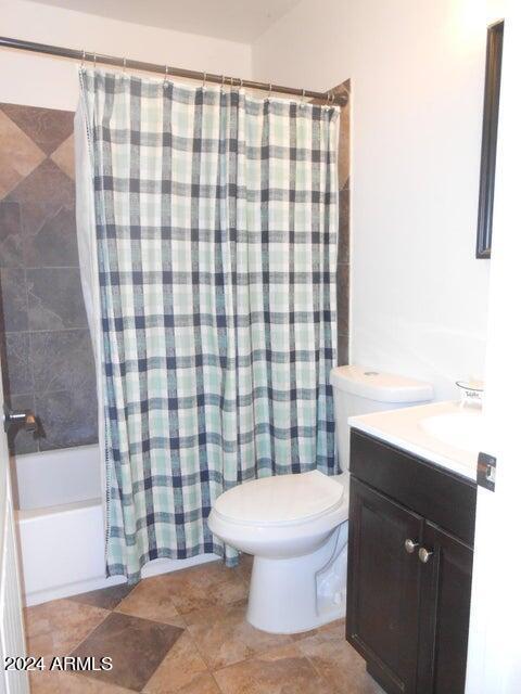 full bathroom featuring shower / tub combo, vanity, and toilet