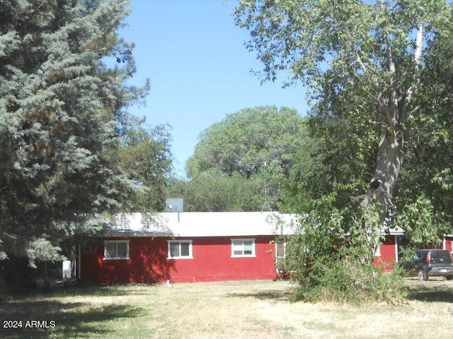 view of property exterior with a yard