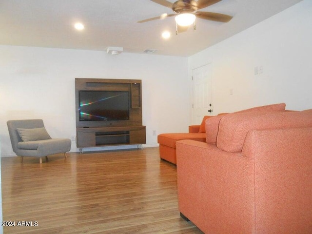 living room with ceiling fan and wood-type flooring