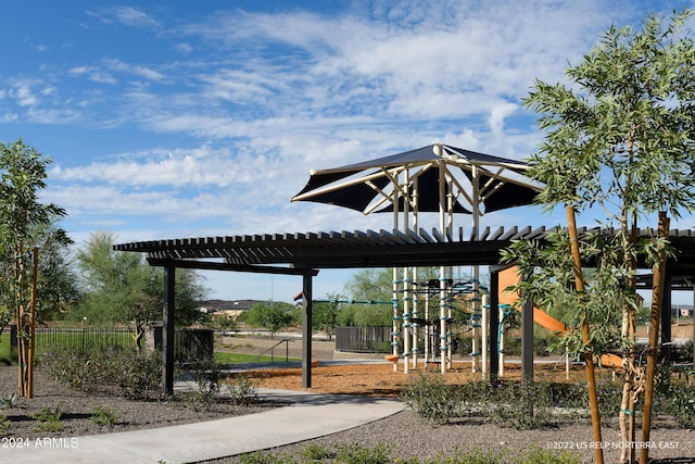 view of home's community with playground community and a pergola