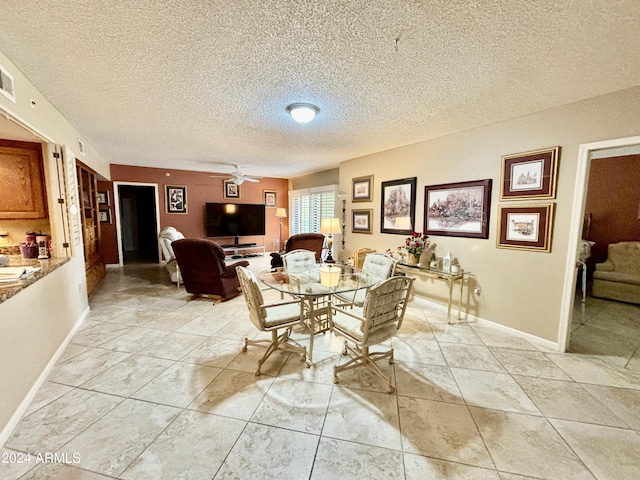 dining room with a textured ceiling and ceiling fan