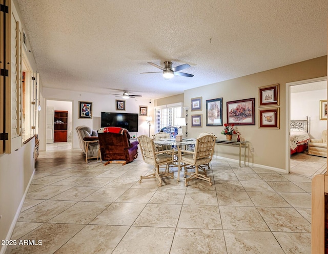 dining room featuring light tile patterned floors, a textured ceiling, and ceiling fan