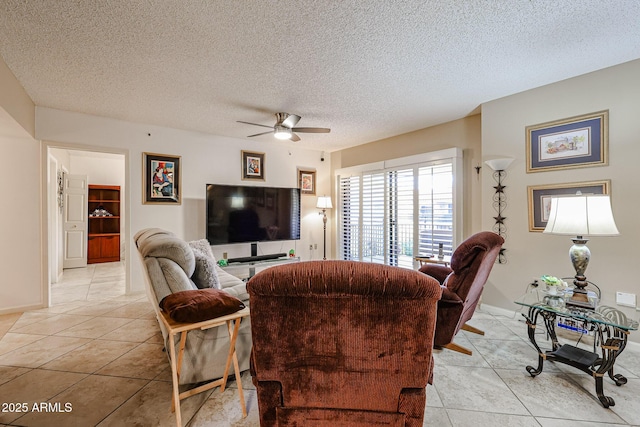 tiled living room with ceiling fan and a textured ceiling