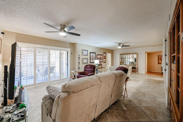 tiled living room featuring a textured ceiling and ceiling fan