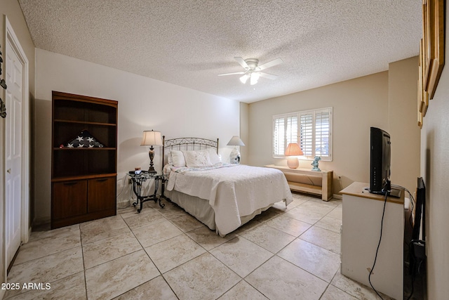 bedroom featuring light tile patterned floors, a textured ceiling, and ceiling fan