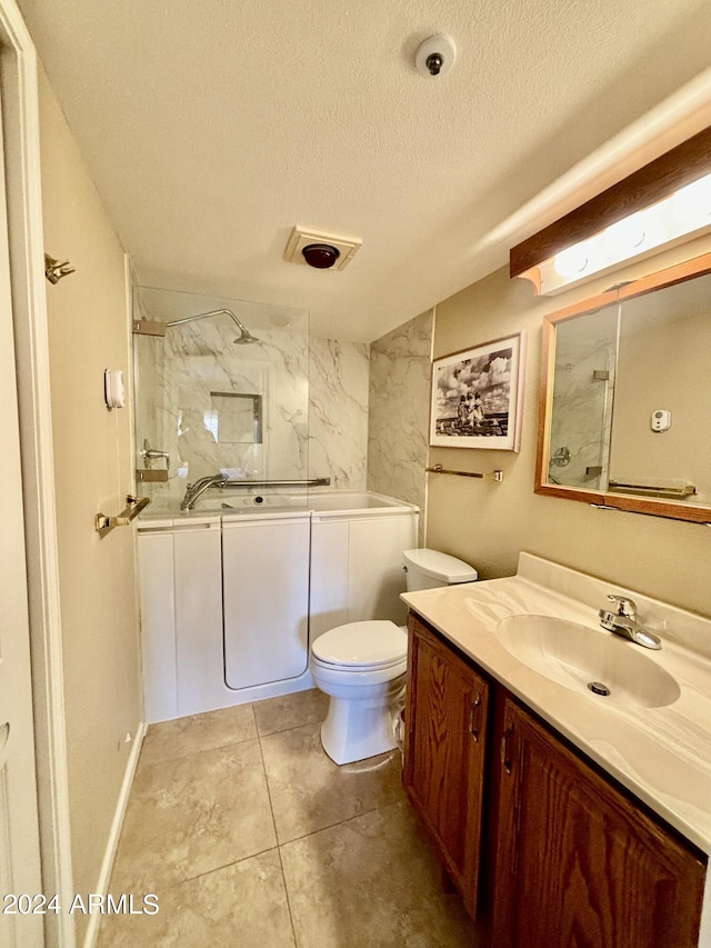 full bathroom with tiled shower / bath combo, vanity, a textured ceiling, and toilet