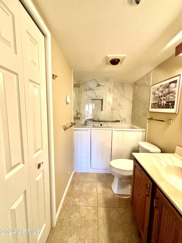 full bathroom featuring tiled shower / bath combo, vanity, a textured ceiling, and toilet