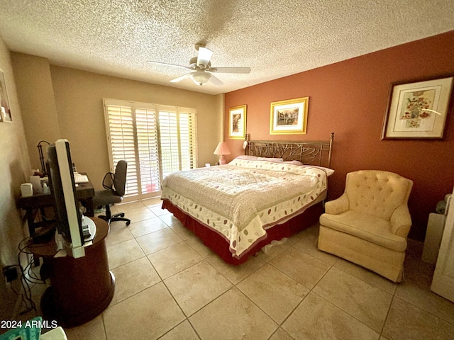 tiled bedroom featuring a textured ceiling and ceiling fan