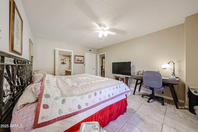 bedroom featuring connected bathroom, ceiling fan, a textured ceiling, and light tile patterned flooring