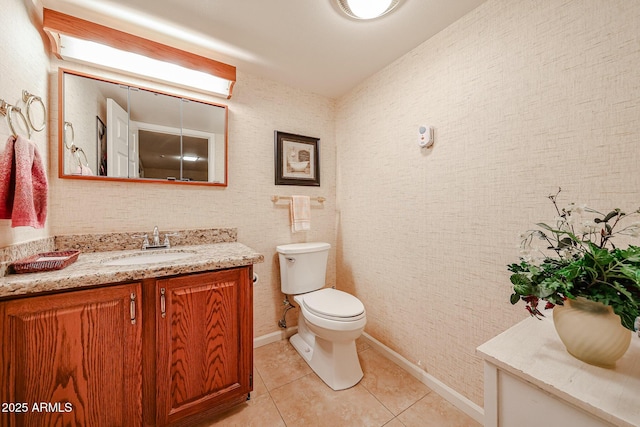 bathroom featuring vanity, tile patterned floors, and toilet