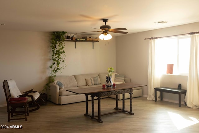 living room featuring hardwood / wood-style floors and ceiling fan