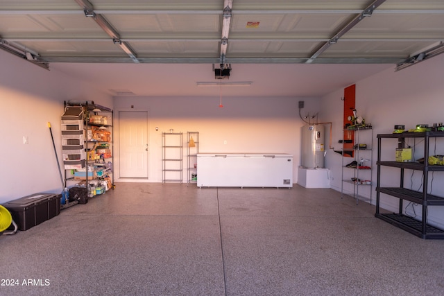 garage featuring electric water heater and a garage door opener