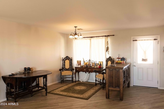 interior space with an inviting chandelier and dark hardwood / wood-style flooring