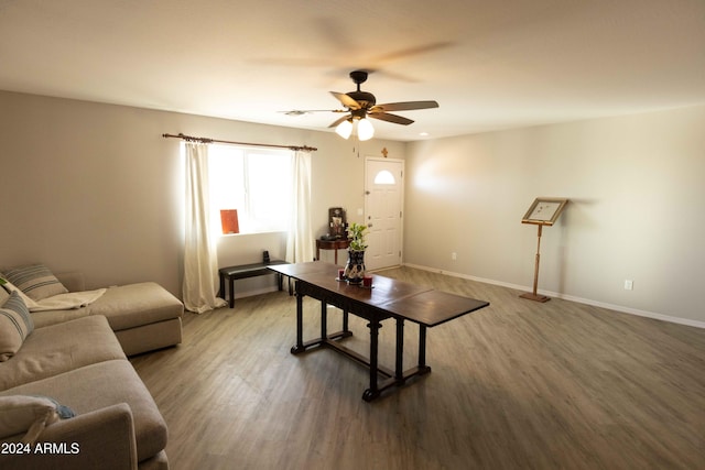 living room with wood-type flooring and ceiling fan