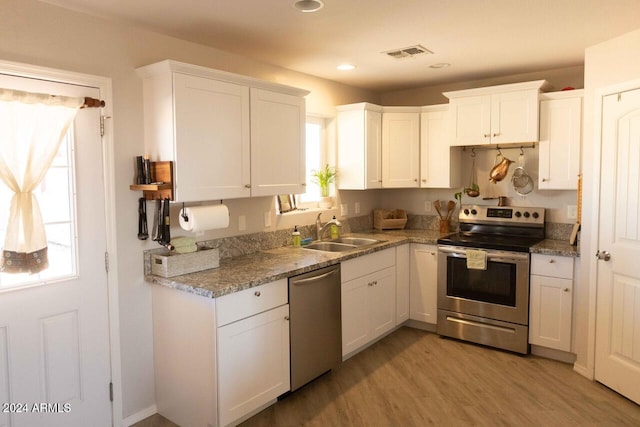 kitchen featuring white cabinets, a wealth of natural light, and stainless steel appliances