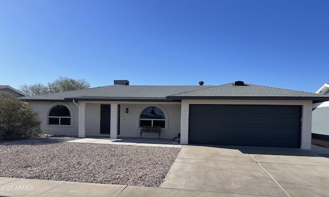 4151 E Clovis Ave, Mesa, AZ 85206 - ranch-style home featuring driveway, brick siding, an attached garage, covered porch, and roof with shingles