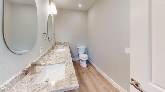 4151 E Clovis Ave, Mesa, AZ 85206 - bathroom featuring toilet, double vanity, wood finished floors, and baseboards